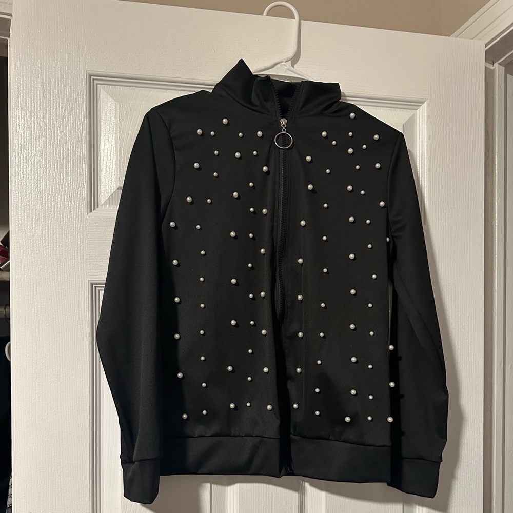 Black pants and jacket with white pearls.